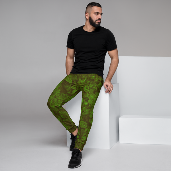 man wearing a green leaf pants, posing model, left side