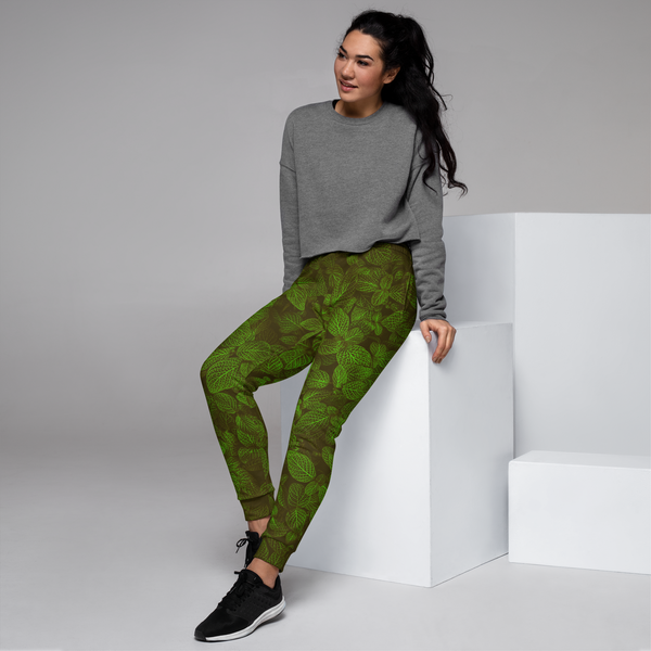 woman wearing a green leaf pants, posing model, left side