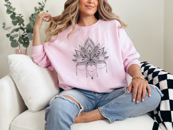 woman wearing a pink sweatshirt with lotus