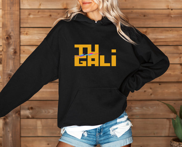 Woman wearing a black motivational hoodie with yellow print