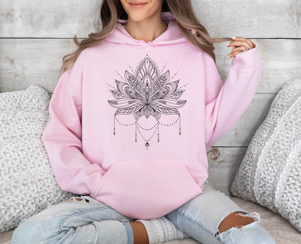 woman wearing a light pink hoodie with lotus